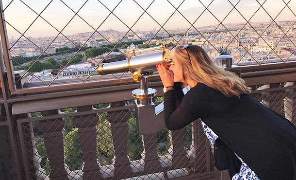 Michaella Caruso surveys the Paris skyline from atop the Eiffel Tower